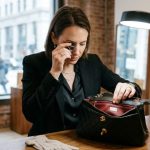 Boutique owner inspecting premium handbag hardware in Chicago